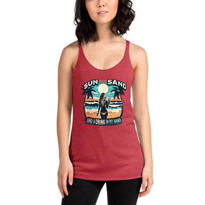 Beach scene on 'Sun, Sand, and a Drink in My Hand' racerback tank, with woman holding cocktail.