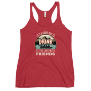 Racerback tank featuring "It's a Good Day to Drink at the Lake with Friends," with people on a boat, lake, and mountains in the background.