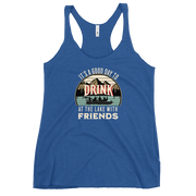 Racerback tank featuring "It's a Good Day to Drink at the Lake with Friends," with people on a boat, lake, and mountains in the background.