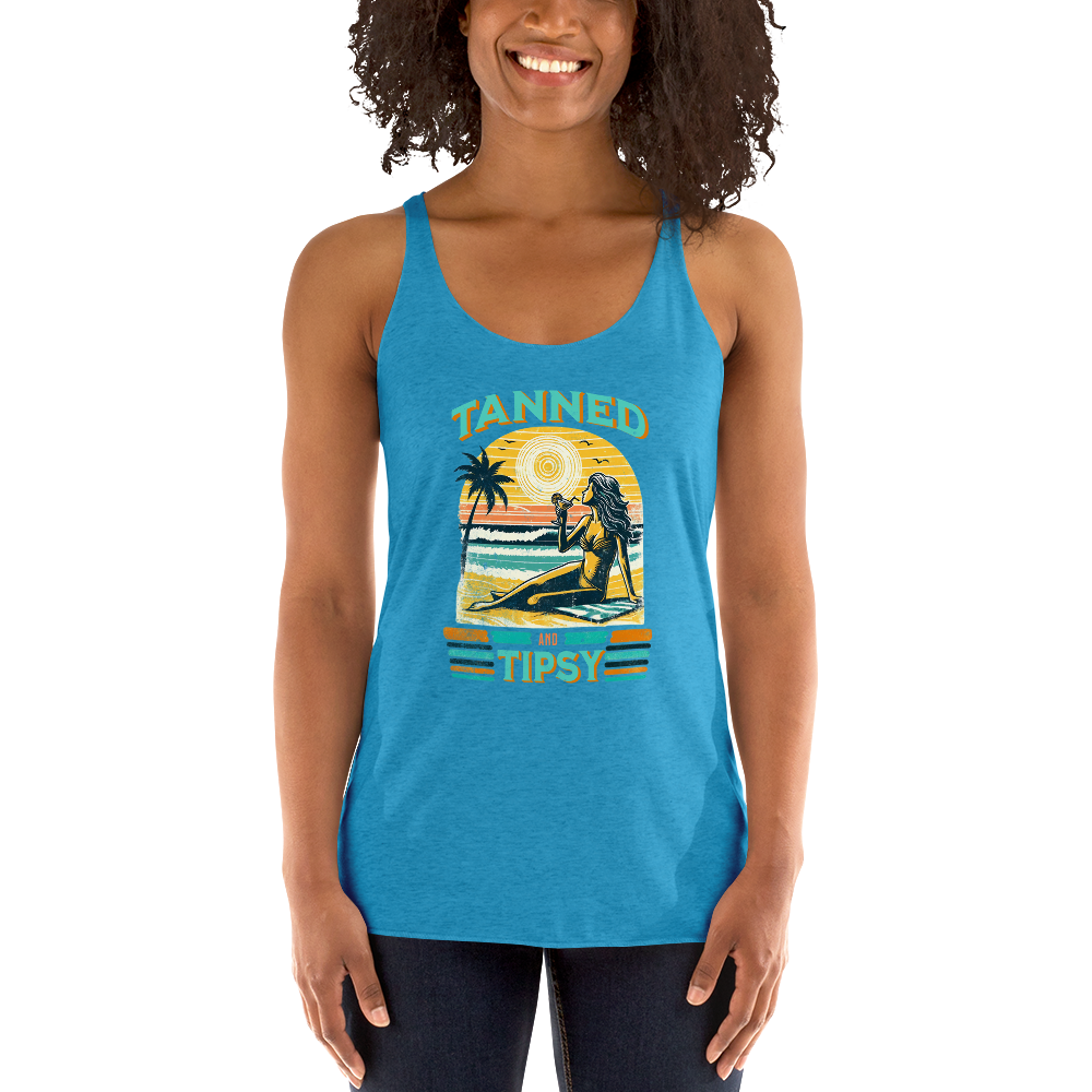 Retro 'Tanned and Tipsy' racerback tank with a woman enjoying a sunset cocktail on the beach, ideal for summer beach parties and day drinking.