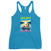 Racerback tank with "Lake Days Are Made for Sipping and Dipping," featuring a woman on a tube float with a cocktail, against a lake and sunset.