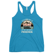 Racerback tank featuring "It's a Good Day to Drink at the Lake with Friends," with people on a boat, lake, and mountains in the background.