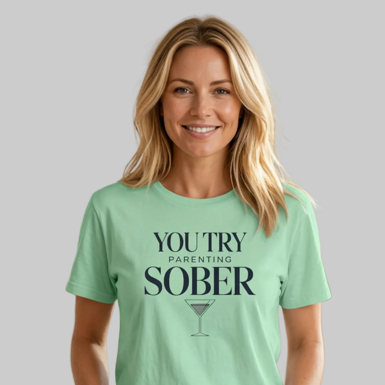 Woman wearing a mint green premium soft-style t-shirt with text 'You Try Parenting Sober' funny mother's day, mom life, father's day design